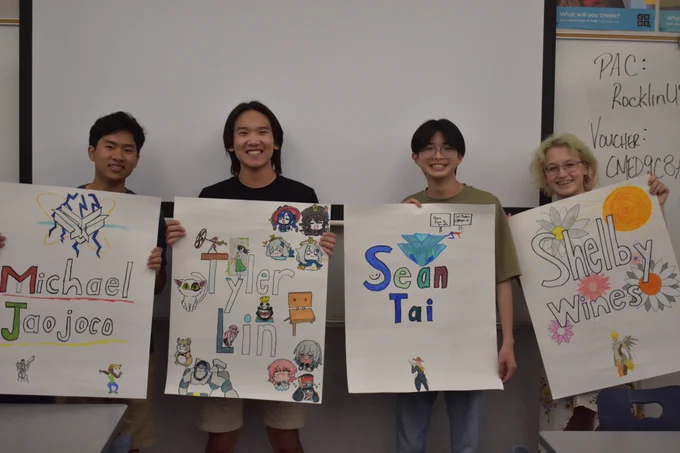 Thunder Esports Graduating Seniors holding posters with their names on them made by their teammates.
