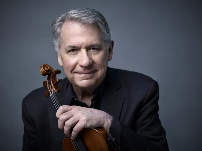 A man holding a violin.