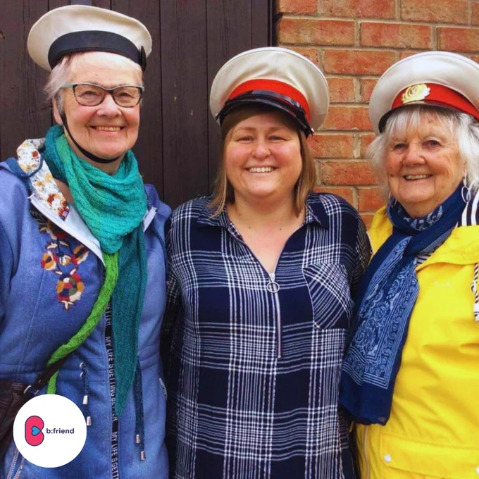 3 women, two older ladies with club leader Jenny in the middle posing with captain hats on. 