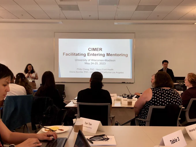 A slide that says “CIMER Facilitating Entering Mentoring” in a room of folks dedicated to research mentorship!