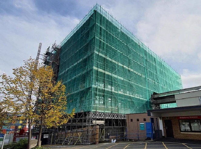 Main tower building at Wycombe Hospital covered in scaffolding