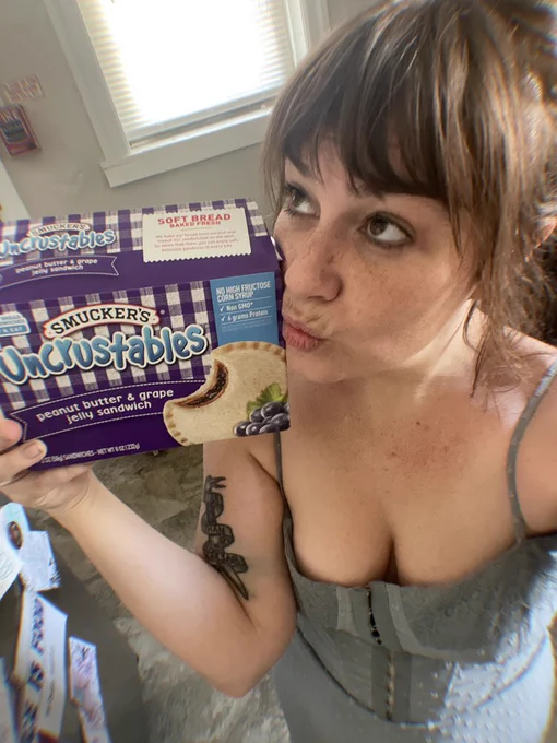 Woman with bangs and a box of uncrustables