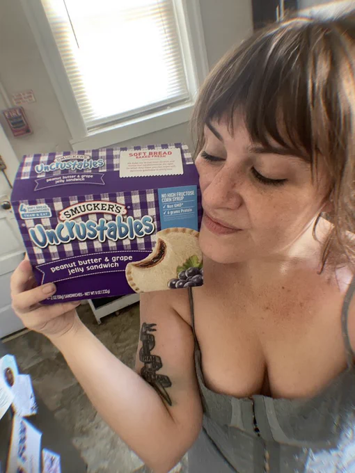 Woman with bangs and a box of uncrustables