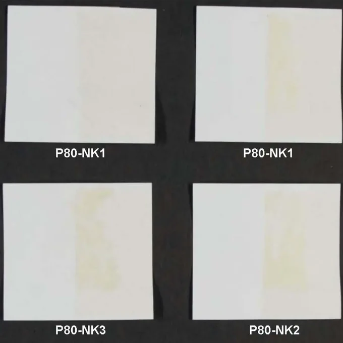 four paper samples lie next to each other in a tile shape. the papers are bright white in places and yellowish in others.