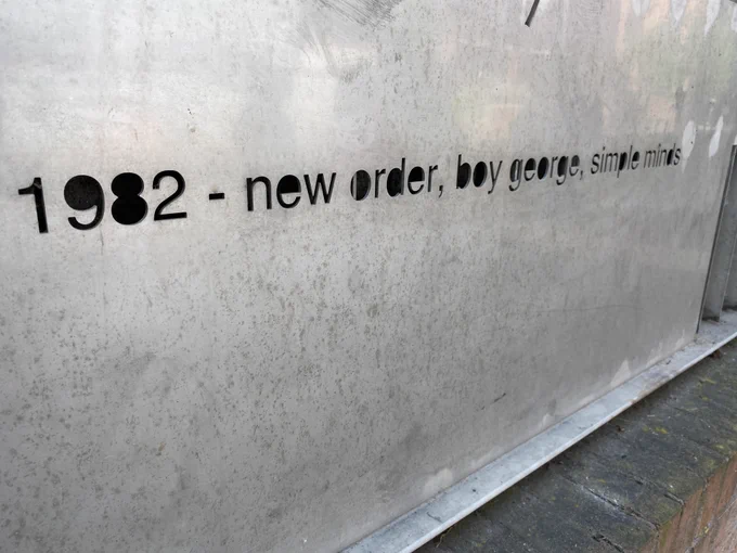 Mural to the former Hacienda Club in Manchester listing artists whore performed there, reading: 1982 - new der, boy george, simple minds.