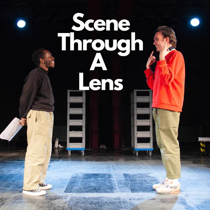 Scene Through A Lens in white text above a photo of two actors on stage one miming a smile the other holding a script behind their back 
