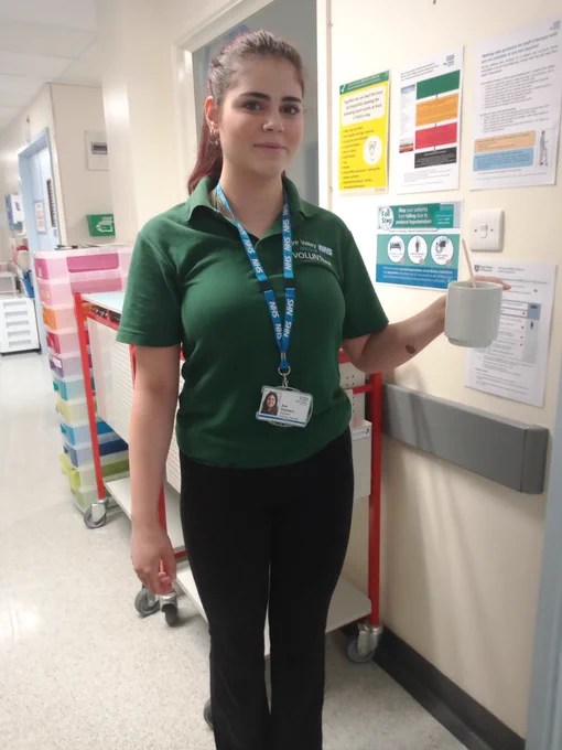 Picture shows Ana, one of our young volunteers. Ana helps to promote hydration by offering drinks to patients on the wards