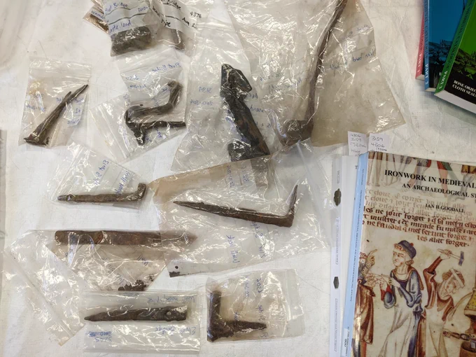 Bags of iron objects with book on medieval ironwork in the corner by Goodhall.