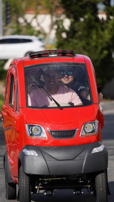 Three Adults in a Tiny Electric Car