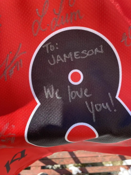 A T6 jersey signed “To Jameson, We Love You!”
