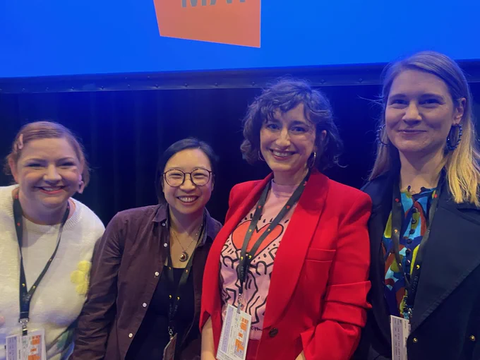 A photo of four women standing onstage at Sydney Writers Festival. All four are smiling at the camera.