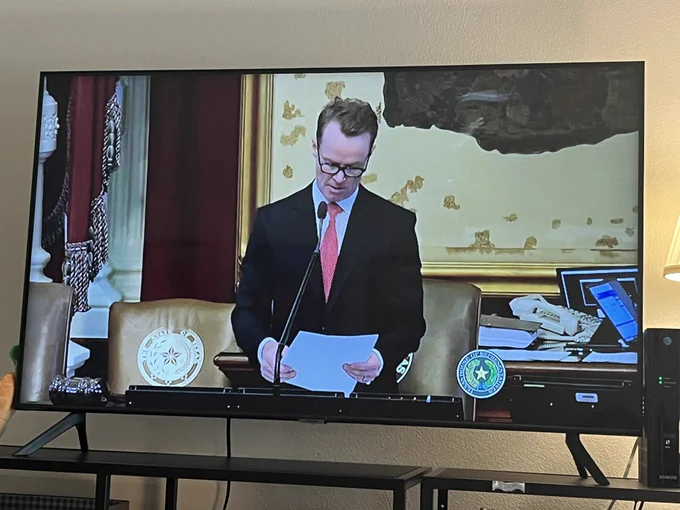 TV showing Speaker Dade Phelan beginning impeachment proceedings