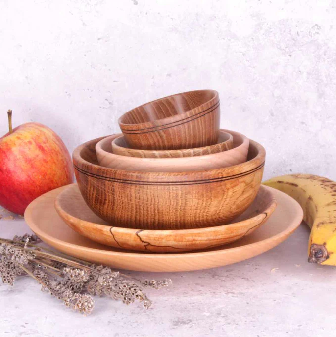 Photograph of artwork by David Rodgers which shows wood turning. Wooden bowls and plates are stacked on top of one another.