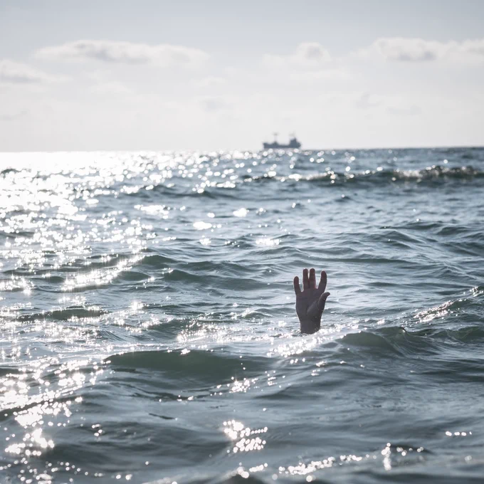 Hand of someone drowning in the sea