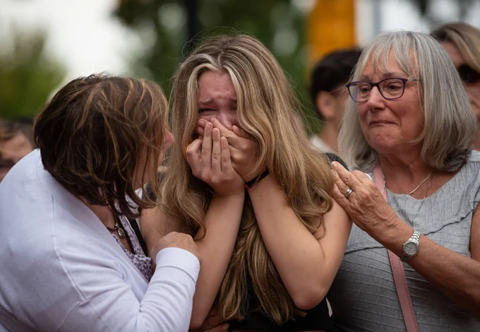 
Caption:
Steven Furness' daughter is comforted by her grandmother Lorraine Furness, right, and a family friend as she cries during a vigil for her father and Paul
Wynn, who were killed by a gunman during a series of attacks on homeless people last month, in Langley, B.C., on Wednesday, August 3, 2022. The
suspect believed to be responsible for the shooting of four people, including the two fatalities, was shot and killed by the RCMP