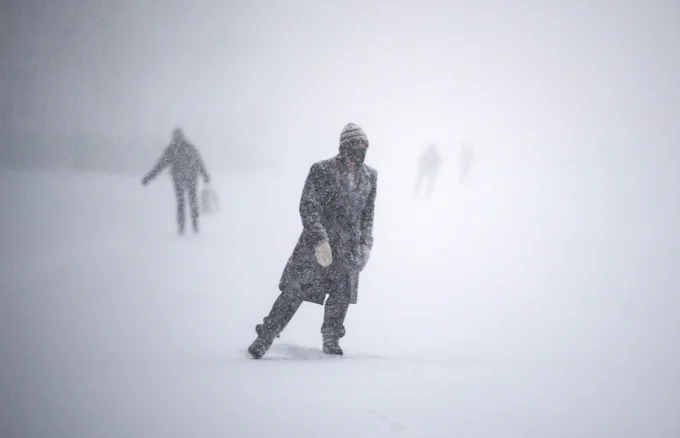People skate on the Rideau Canal Skate-way amid heavy snow and driving wind in Ottawa, on Monday, Jan. 17, 2022.