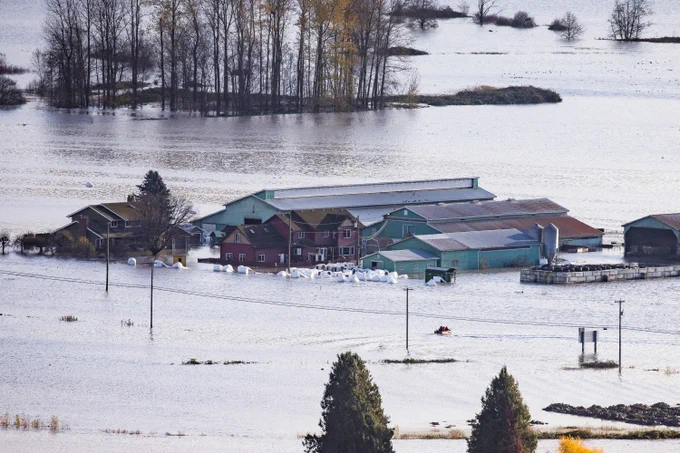 A search and rescue boat transports the Meier family from their flooded farm in the community of Sumas Prairie during flooding in Abbotsford, British Columbia on Tuesday, November 16, 2021. 