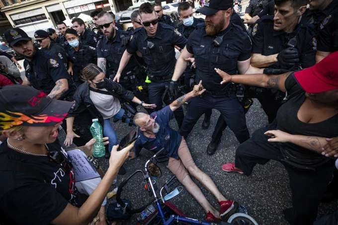 Vancouver police officers arrest multiple people during a melee while the city attempted to remove unhoused people living in tents on East Hastings in the Downtown Eastside neighbourhood in Vancouver, British Columbia on Tuesday, August 9, 2022.  (Ben Nelms/CBC)