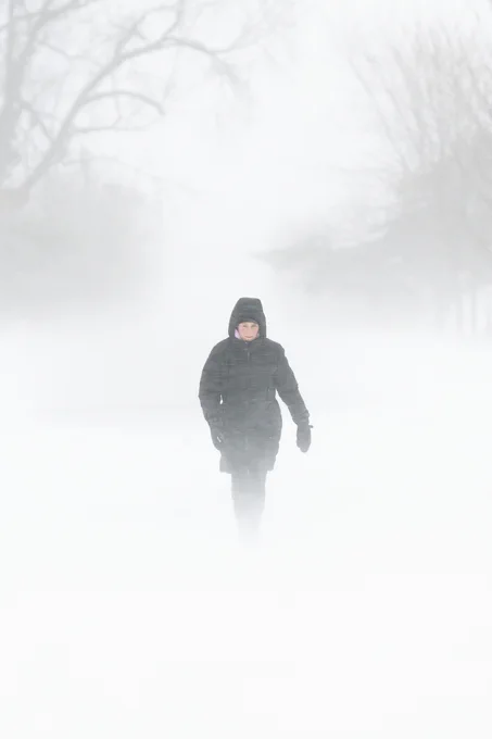 A person makes their way through the Experimental Farm in Ottawa, on Saturday, Dec. 24, 2022. Environment Canada has issued a winter storm warning for the region. 