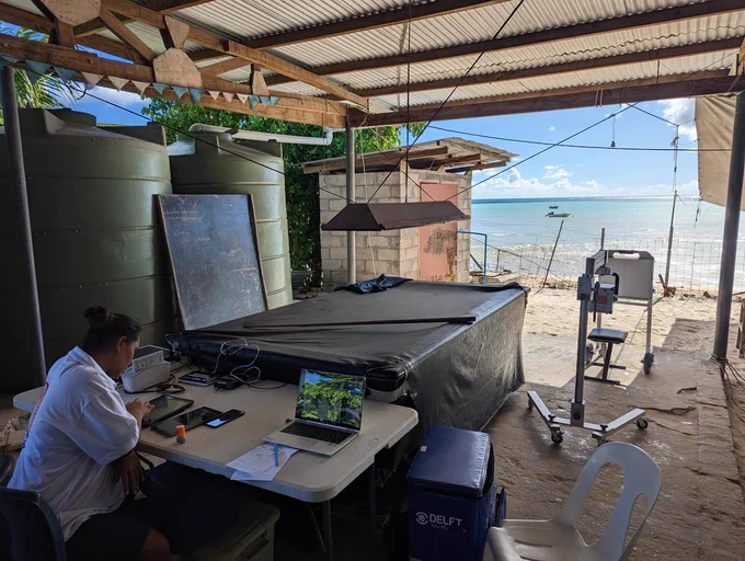 Portable x-ray and cad4tb system with a health worker at a beachside location