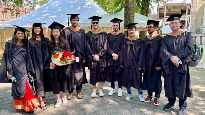 Master in Finance graduates preparing for the hooding ceremony