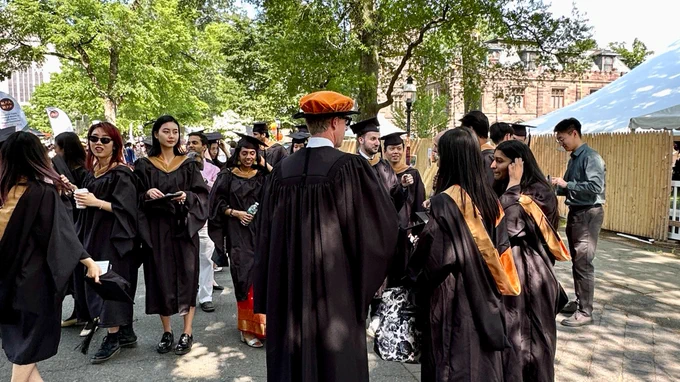 Master in Finance graduates preparing for the hooding ceremony