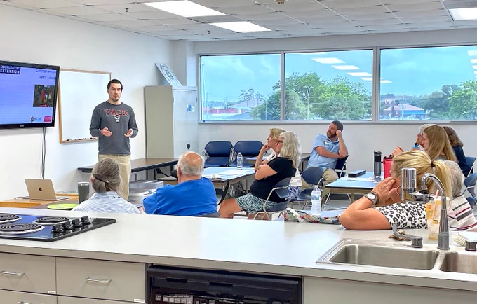 Dr. Chouljenko presents information to the class, focusing on local seafood preparation and safe cooking practices, with a lunchtime food demonstration after class.