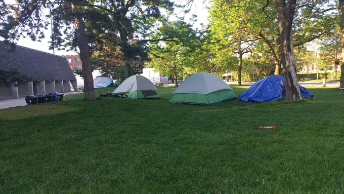 A daylight photo of four tents in the park by Lamport Stadium