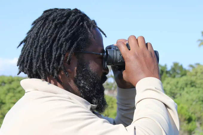 Nick using binoculars