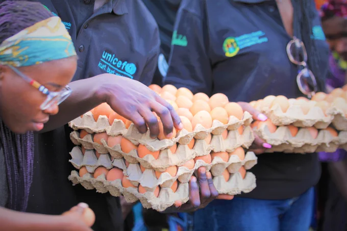 Volunteers hand out eggs to children at the event.