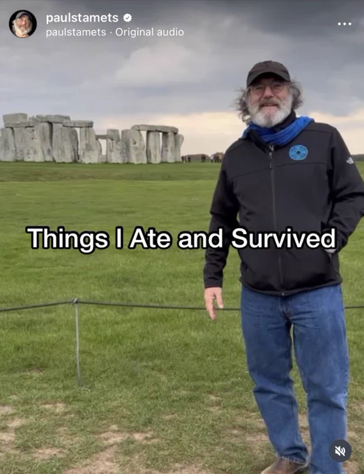 a screen shot of an Instagram story from paul stamets’ account. he is standing on grass with stone henge in the background, wearing jeans and outdoor clothes. in white text across the image it says “Things I Ate and Survived”
