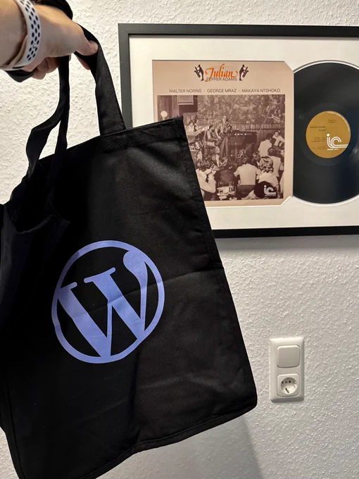 WordPress Blue Logo Tote in front of the Julian record by Pepper Adams. Pepper was the release name of WordPress 4.6.