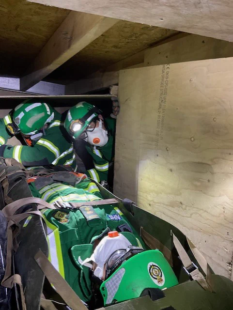 A picture of a training session where Hazardous Area Response Team medics are practising the rescue of a patient from a collapsed building. 