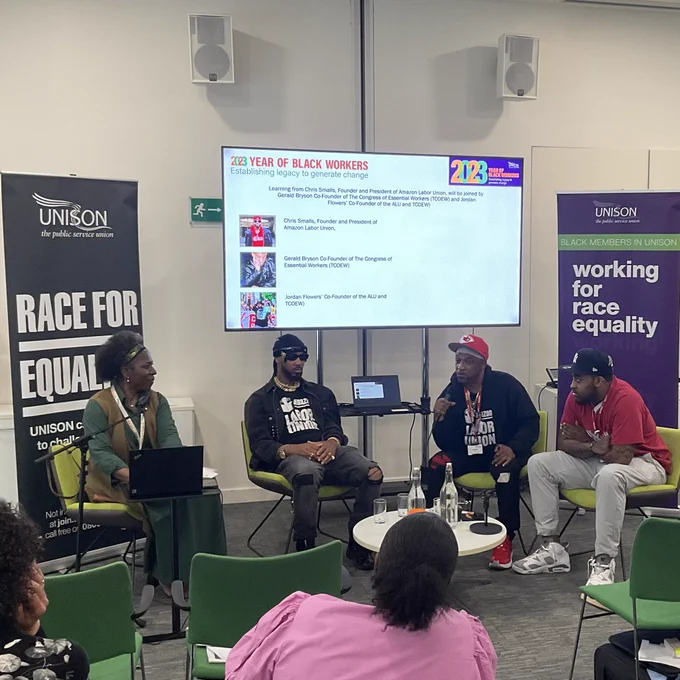L to r Margaret Greer, Chris Smalls, Gerald Bryson, Jordan Flowers seated talking to an audience of Black members at UNISON centre