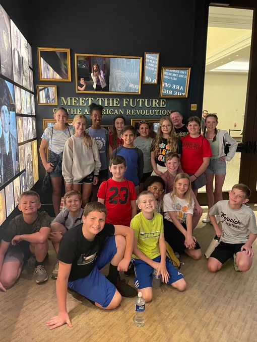 large group picture of students with the text, 'Meet the Future of the American Revolution' written behind them
