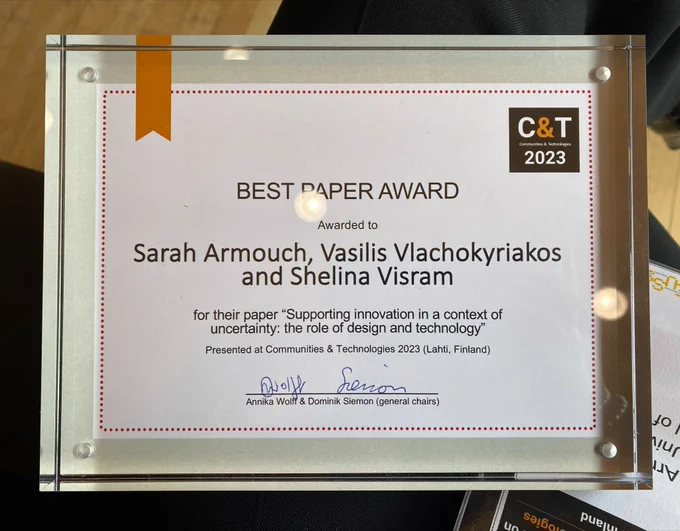 It is a certificate that says: Best Paper Award. Awarded to Sarah Armouch, Vasilis Vlachokyriakos and Shelina Visram for their paper "Supporting innovation in a context of uncertainty: the role of design and technology". Presented at Communities and Technologies 2023, Finland. And it is signed at the bottom. 