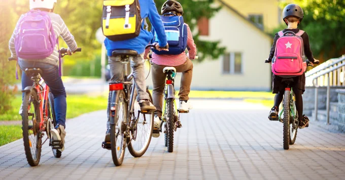 Kids riding bicycles to school.