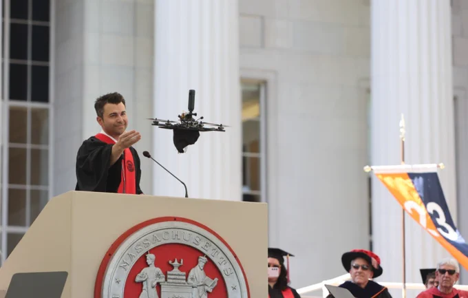 Mark Rober lets go of his mortarboard attached to a drone and it flys away.