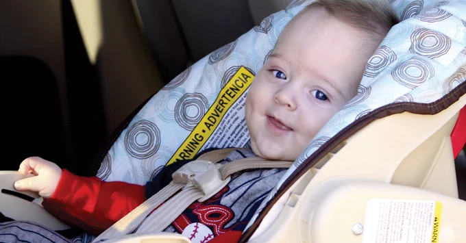 Baby in a rear-facing car seat.