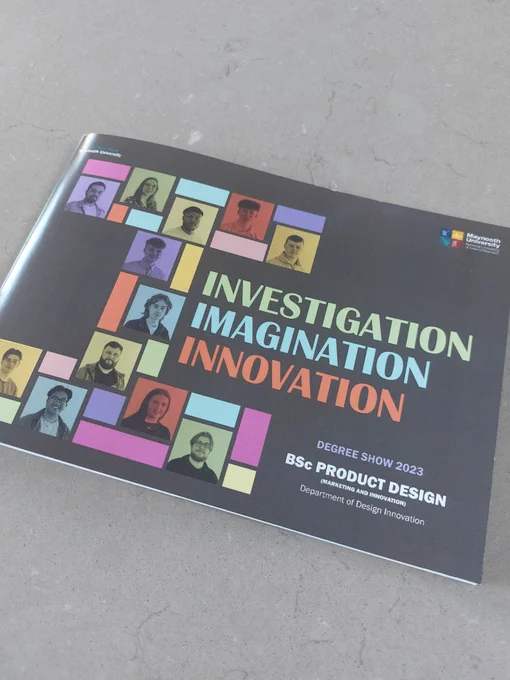 Brochure on table. The cover has images of students on it and the words: Investigation, Imagination, Innovation. Degree show 2023 BSC Product Design. 