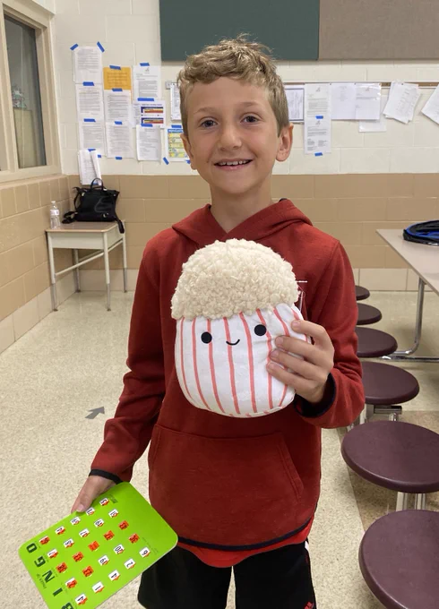 Student with bingo card and prize