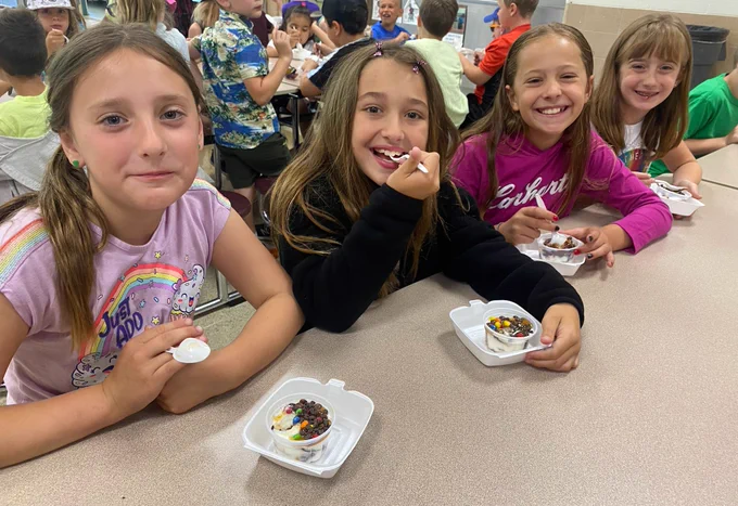 Student with ice cream sundaes.