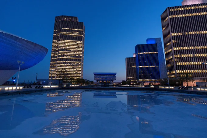 Empire State Plaza at dusk lit up in blue and white to mark 75 years of independence for Israel. 
