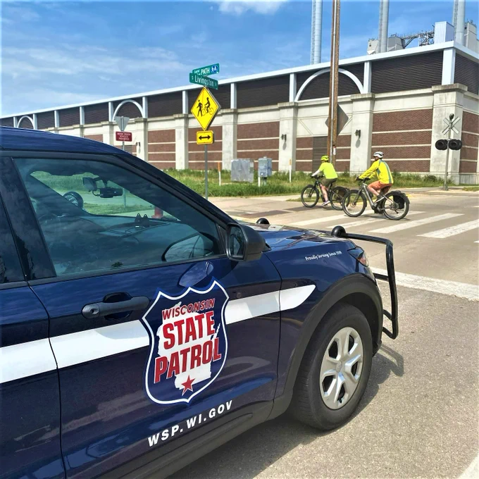 WSP cruiser yielding to bicyclist along a bike path crossing