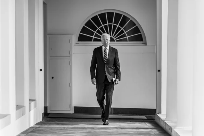 President Biden walks along the West Colonnade of the White House to the Oval Office. 