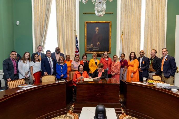 Governor Healey, LG Driscoll, and members of the cabinet wearing orange.