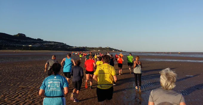 Runners on the sand at low tide 