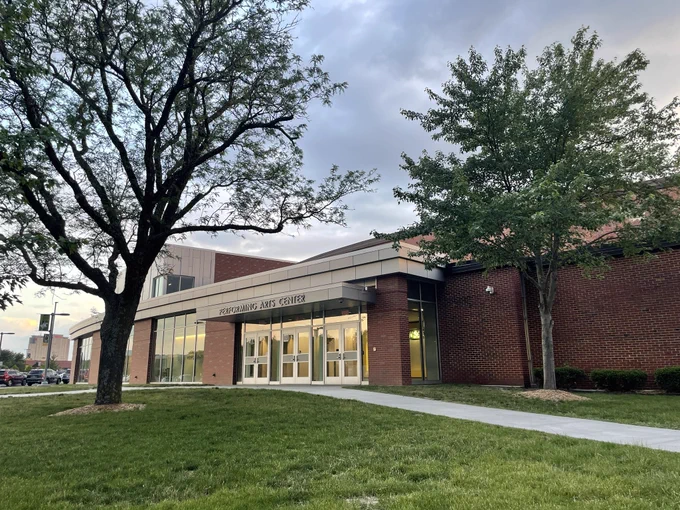 The facade of the Performing Arts Center at Shawnee Mission South High School near dusk.