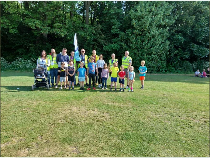 Group photo with junior parkrun flag