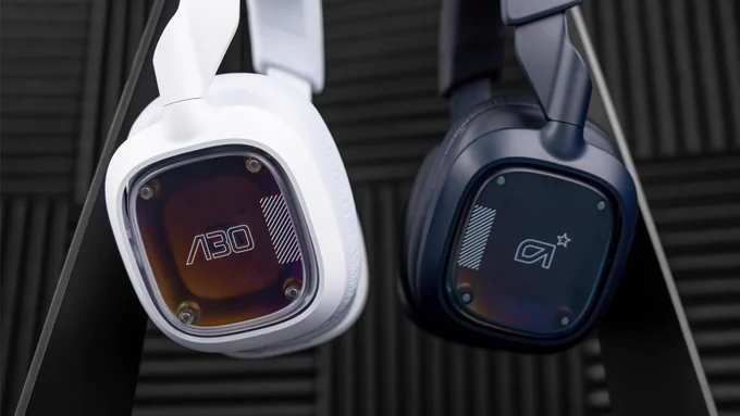 A pair of white and navy Logitech G ASTRO A30s on headset stands. The ear tags are shown with the A30 and ASTRO logos.